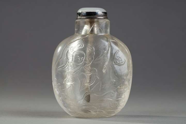Rock crystal snuff bottle sculpted in low relief with liu hai, bat, crane